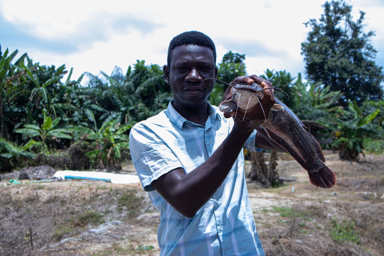 Akin Showemimo posing with a catfish.