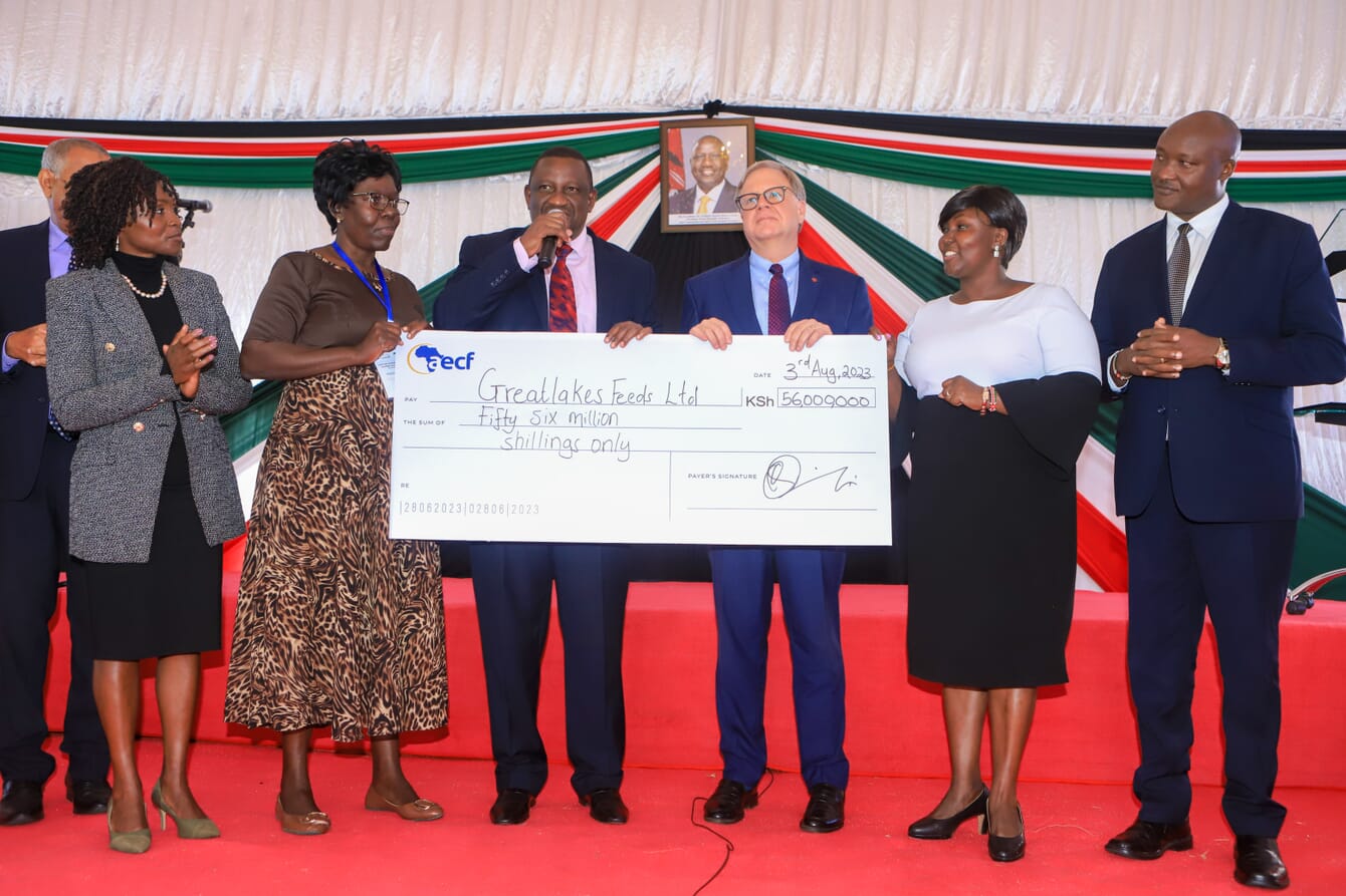Mathildah Amollo receiving cheque on stage