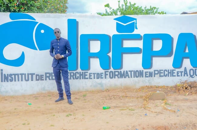 A man standing infront of an aquauclture practical training centre.