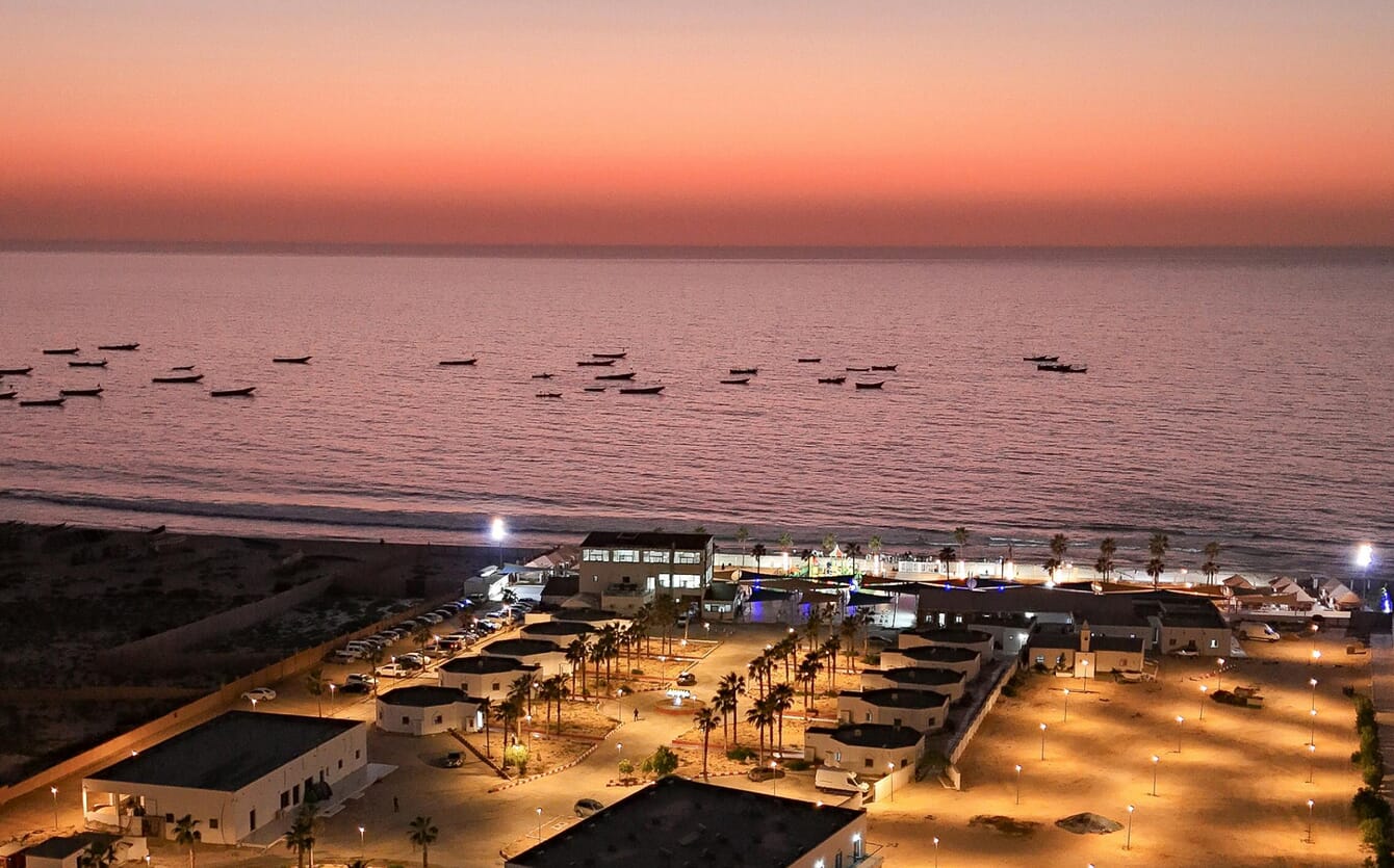 A sunset view of a port in Mauritania with small fishing boats.