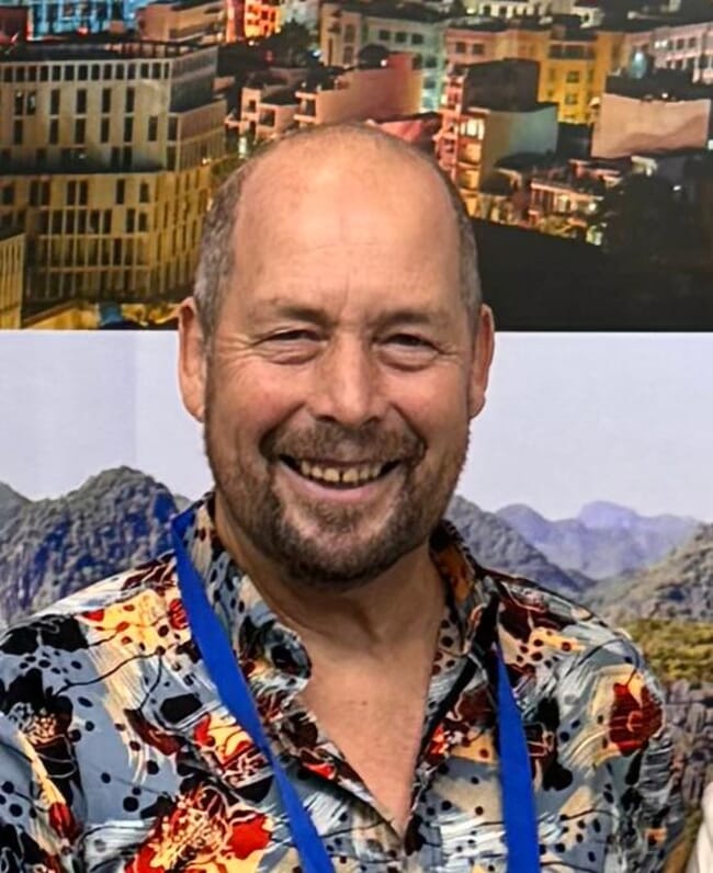 A headshot of a professor at a conference.