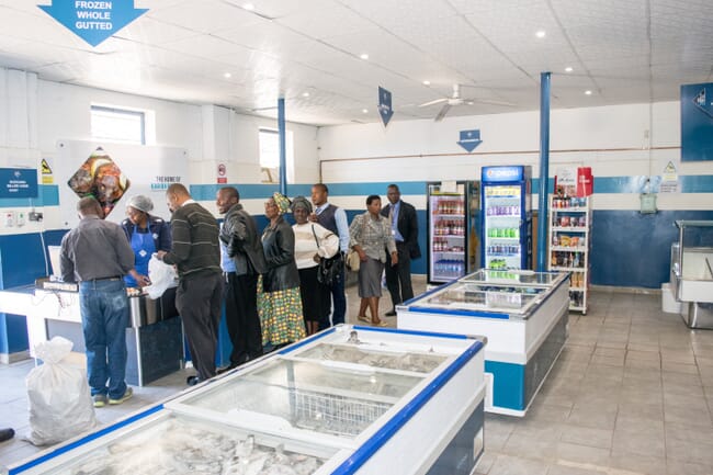 people standing in a fish shop