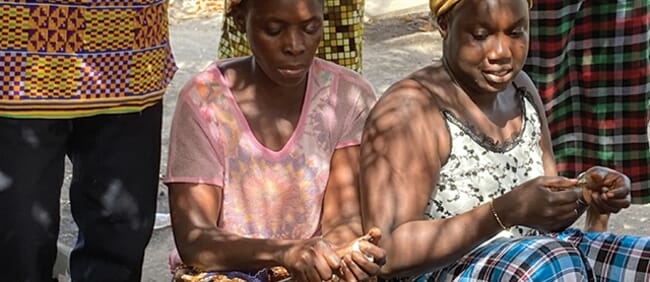 women shucking oysters