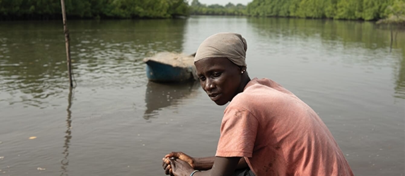 woman sitting near the water