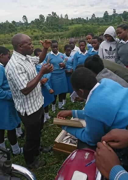 Man teaching school girls