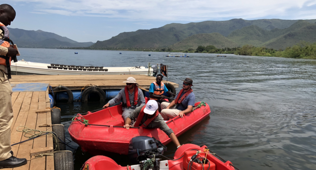 people climbing into boats