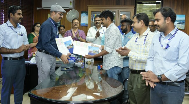 Two groups of people signing an MOU.