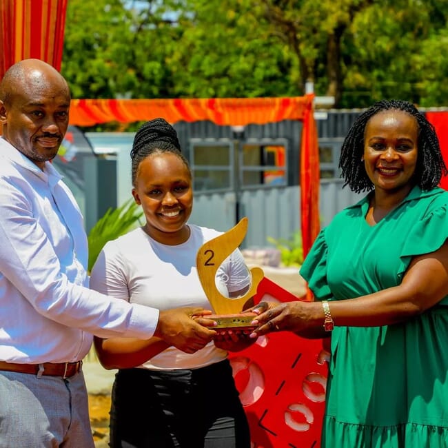 A woman receiving an award from Kenya Red Cross.