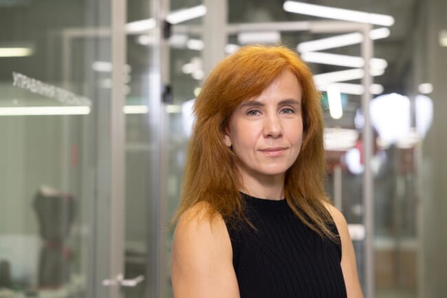 Headshot of a woman in a factory.