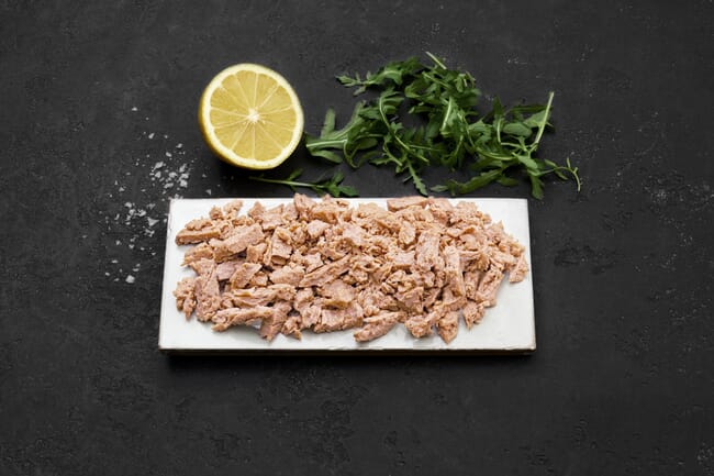 A pulled rainbow trout product with a lemon garnish.