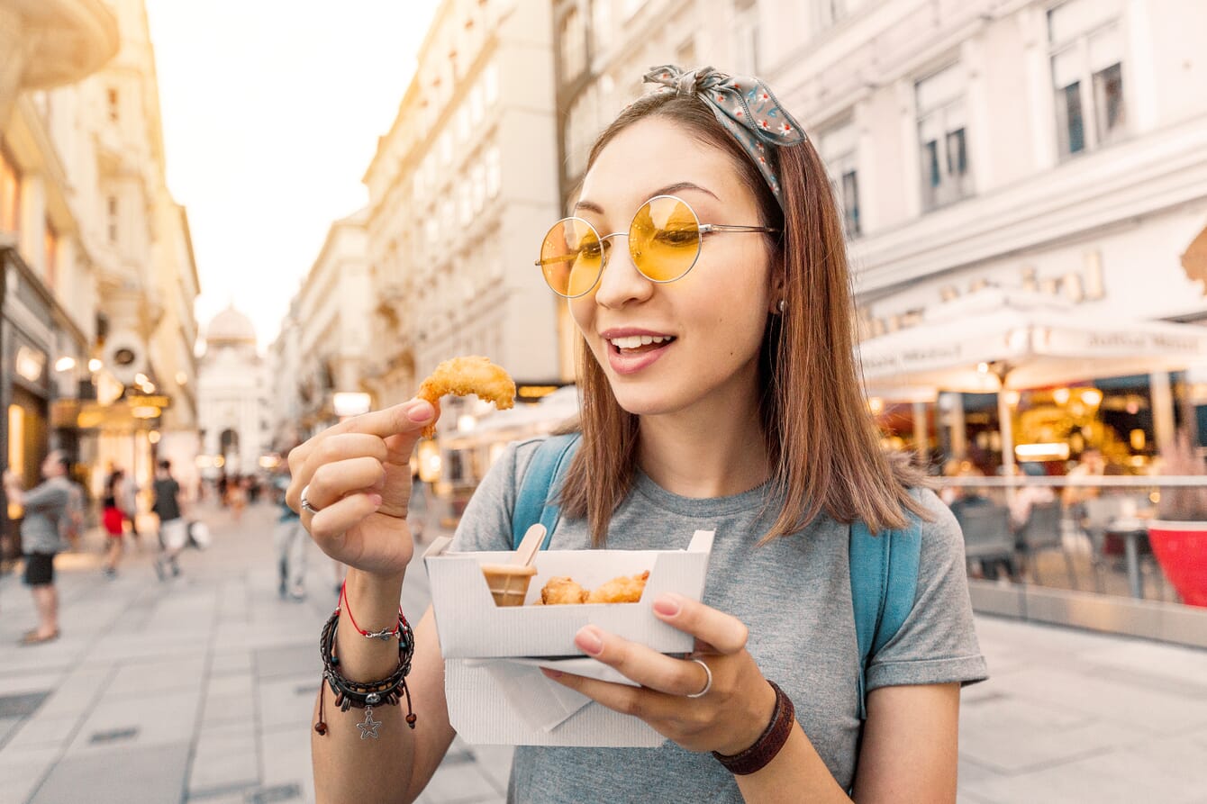 A woman eating a shrimp.