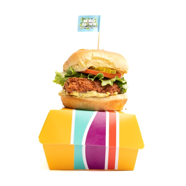 Plant-based burger sitting on takeaway box