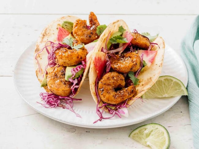 Two plant-based shrimp tacos on a plate.