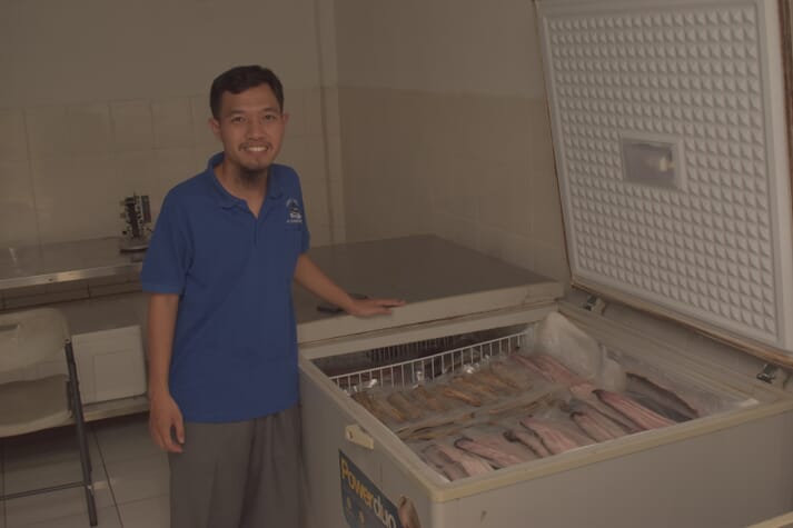 Angga beside frozen eel fillets - one of three products that he's currently selling