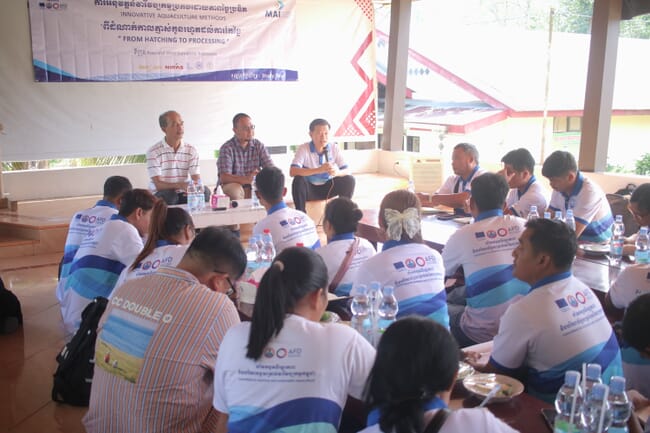 A group of people listening to a presentation.