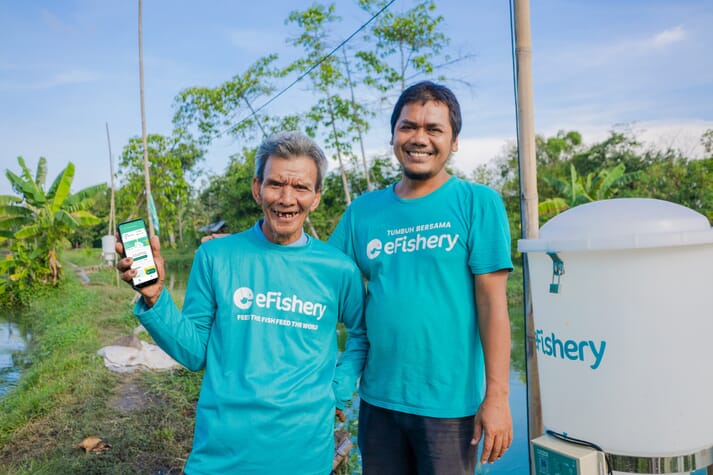Gibran Hu saifah, co-founder and CEO of eFishery (right), with a happy catfish farmer