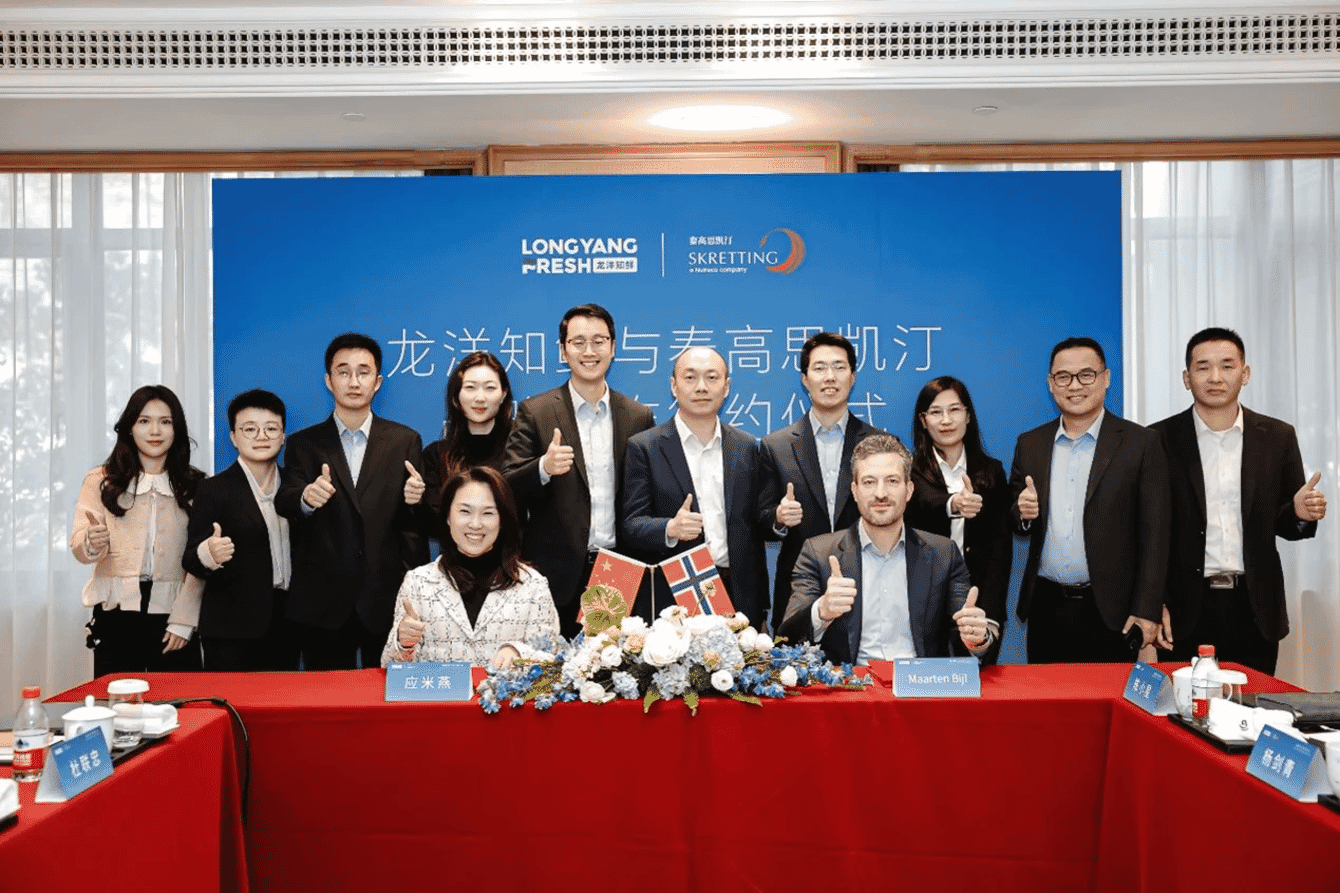 A group of company representatives posing for a photo after signing a business agreement.