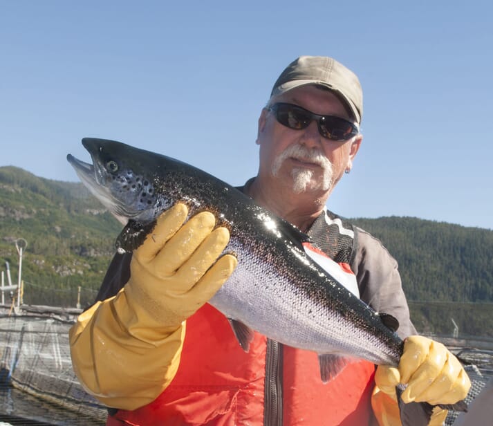 a man holding a salmon