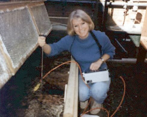 Professor Huntingford beside an artificial stream for studying the behaviour of small salmonids at a field station on Loch Lomond c.1990