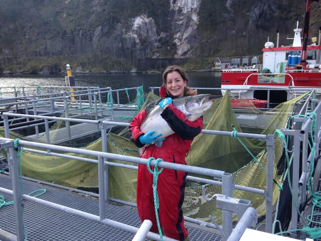 Woman holding a large salmon