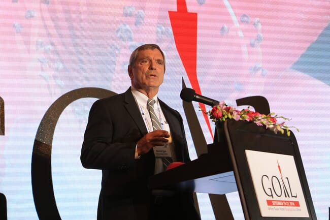 a man speaking on stage at a conference