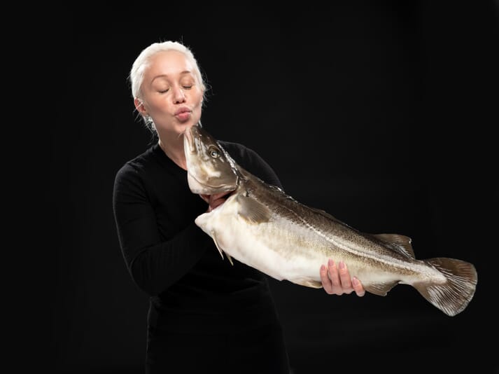 a woman kissing a fish