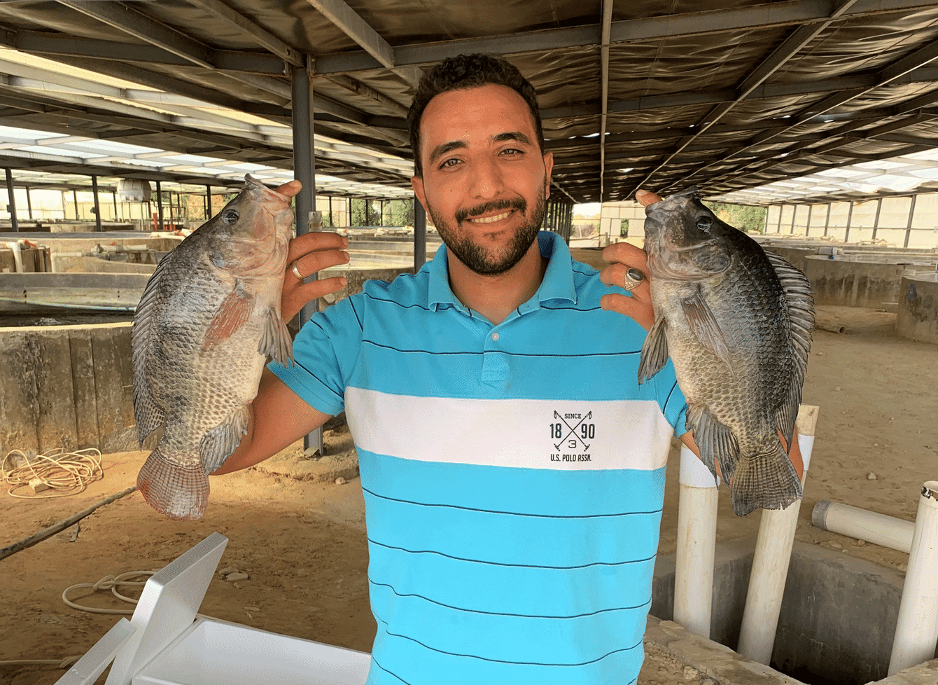 A man holding two fish.