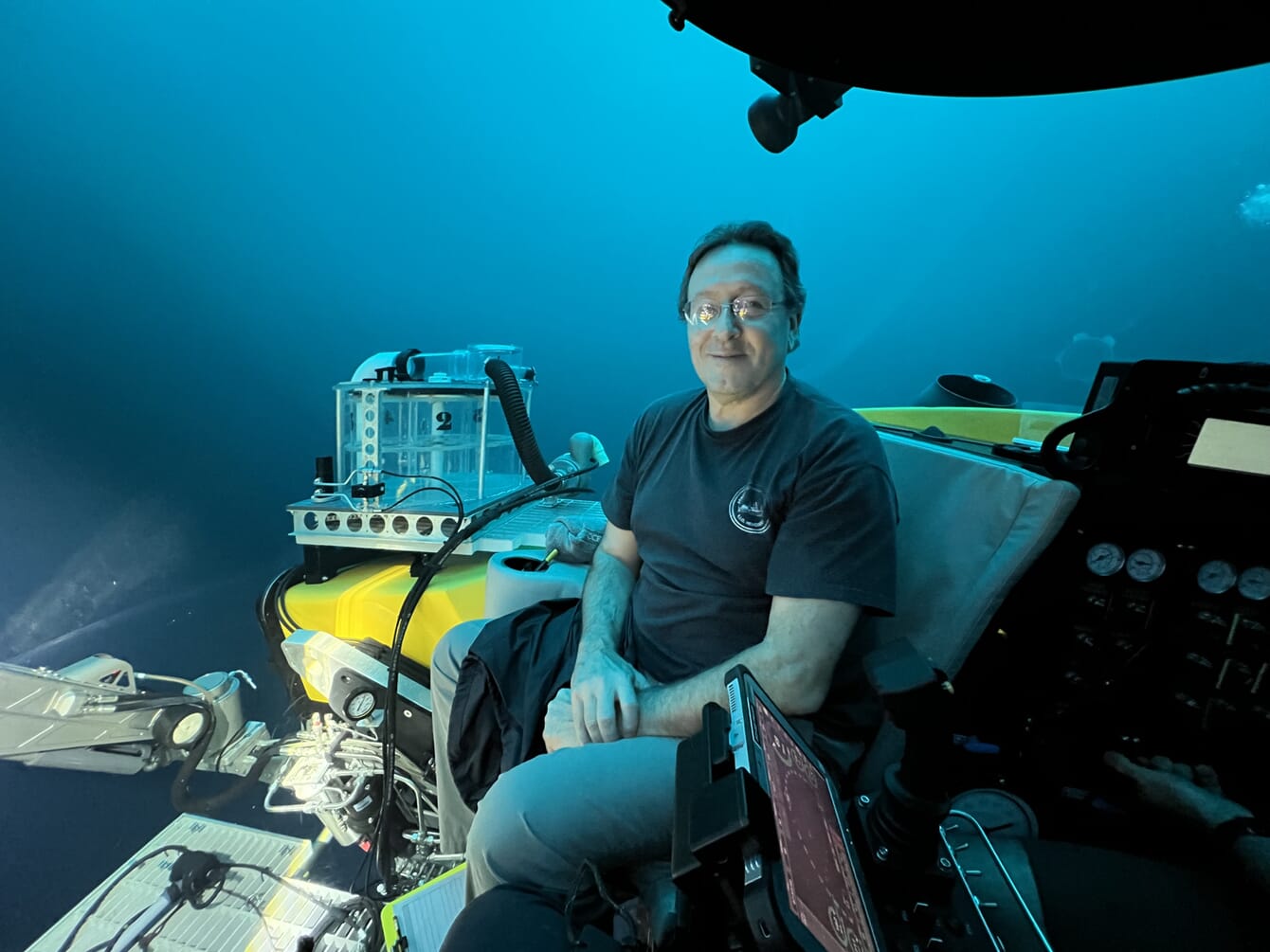 A marine ecologist sitting in a submarine underwater.