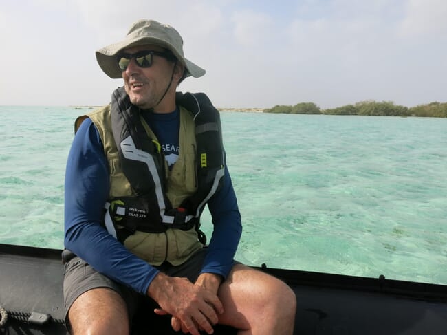 A marine ecologist sitting on a boat during an expedition.