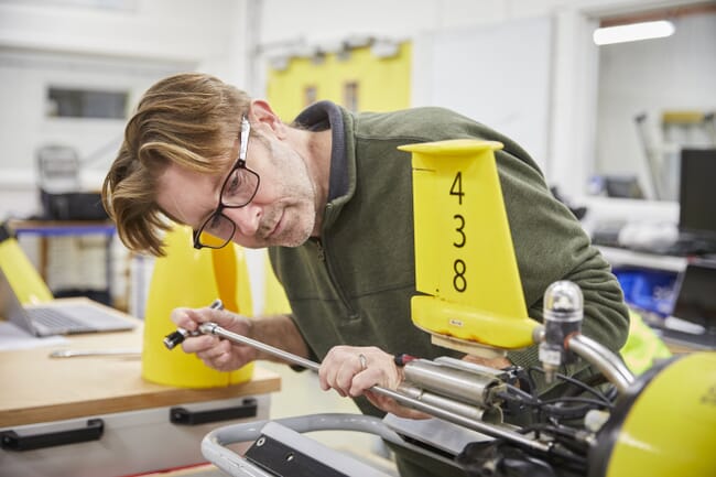 Man working on a machine in a lab