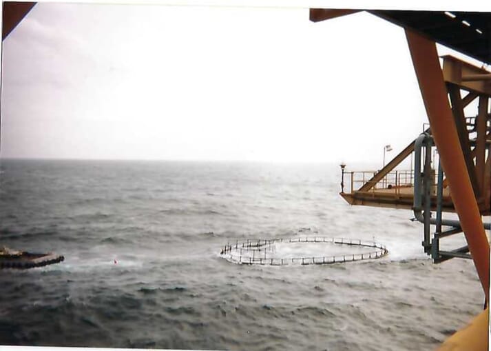 view of aquaculture net pens in choppy water