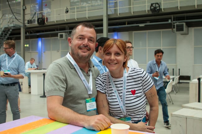 Man and a woman smiling at the camera