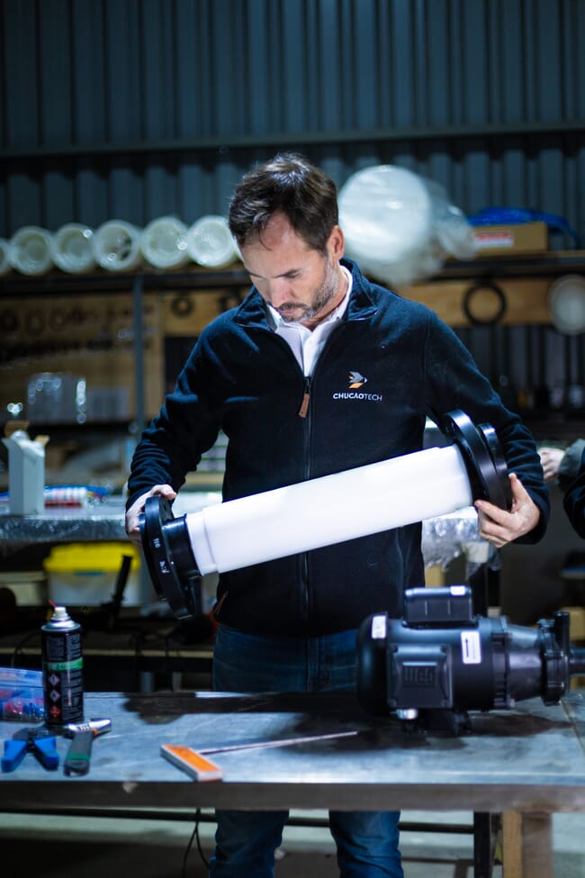A man holding a white cylinder.