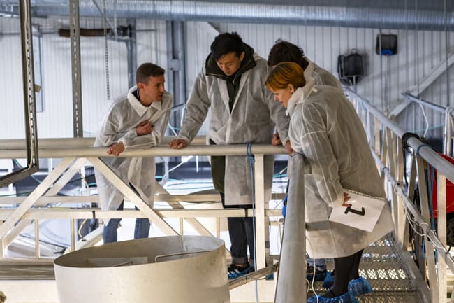 Researchers touring a RAS facility.