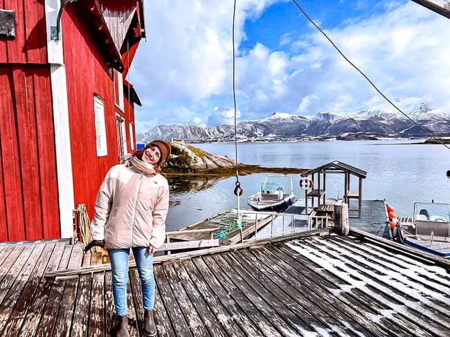a woman standing on a wooden dock