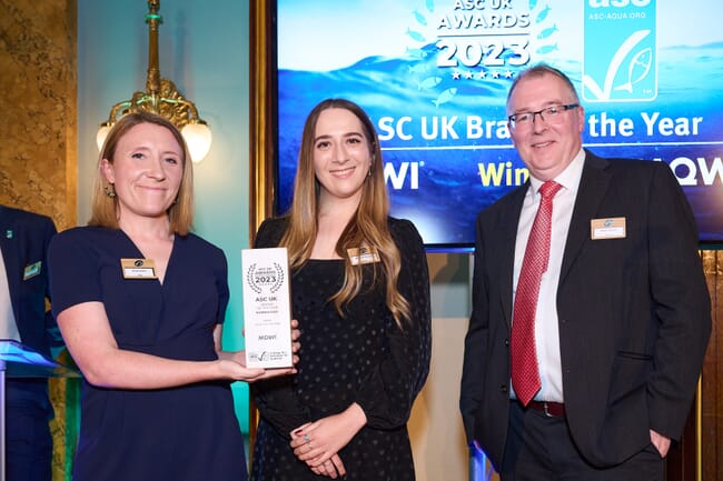ASC representative presenting ASC award to two individuals from Mowi Scottish Salmon for brand of the year.