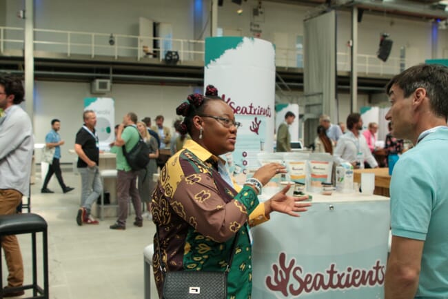 Woman talking to a main at an event stand