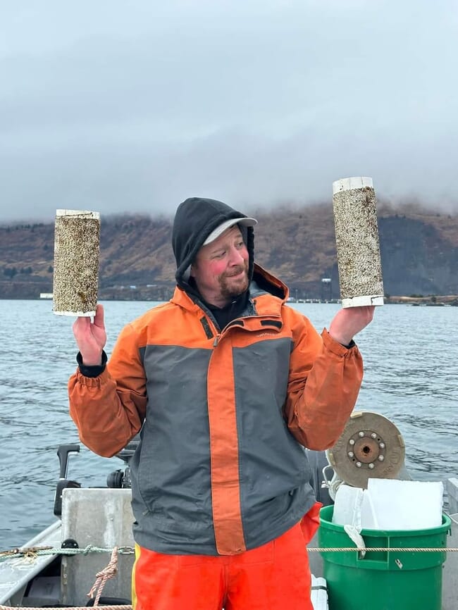 Nicholas Mangini with kelp seeded rope.