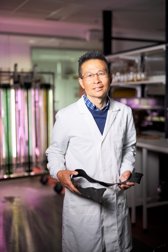 Scientist holds seaweed