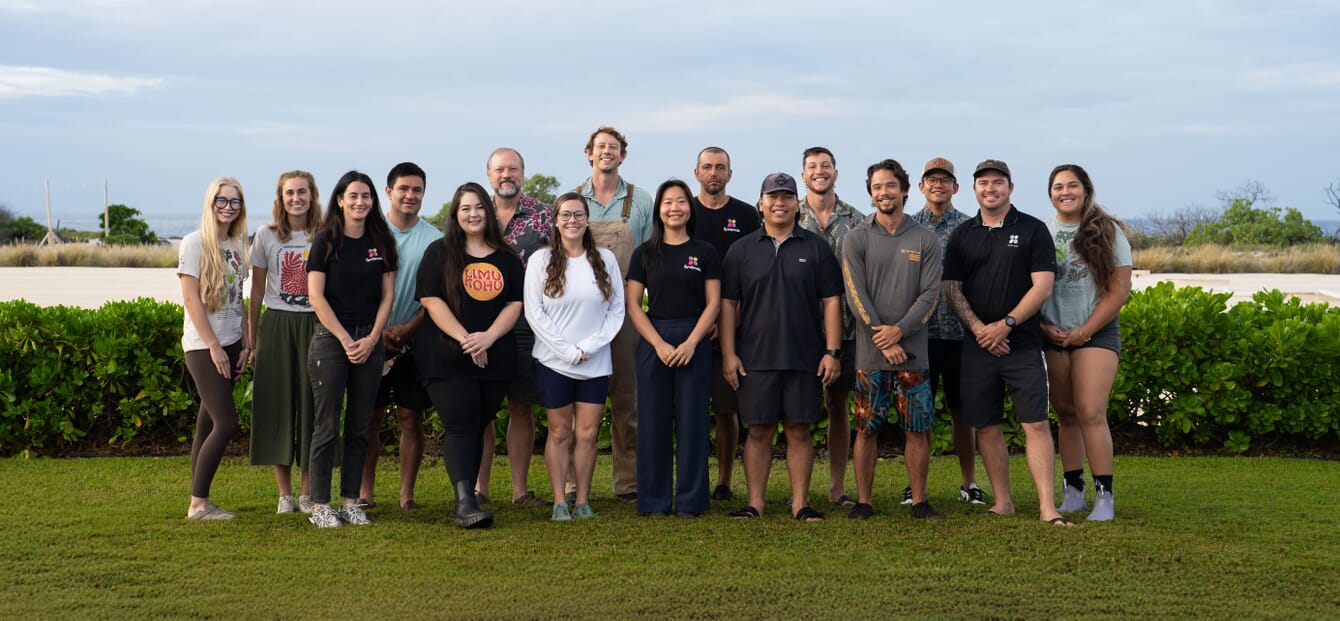 A group team photo of a company which works on cultivating red seaweeds.