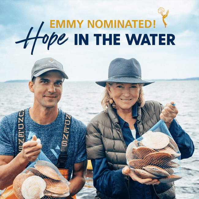 Two people holding bags of scallops.