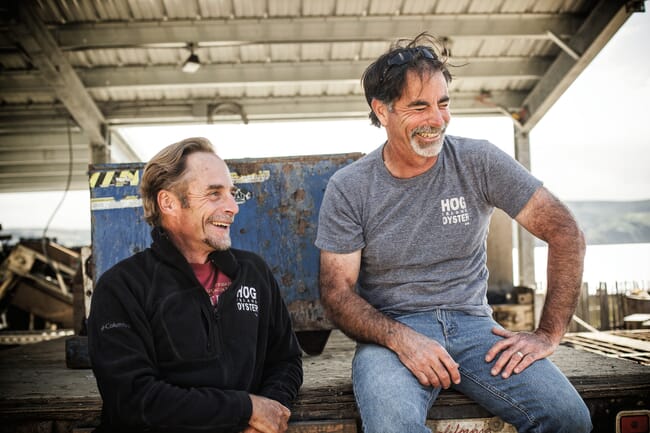 Two men laughing.