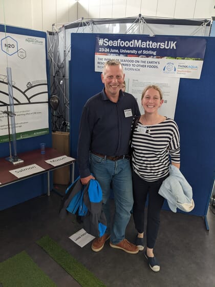 people standing at a conference stand