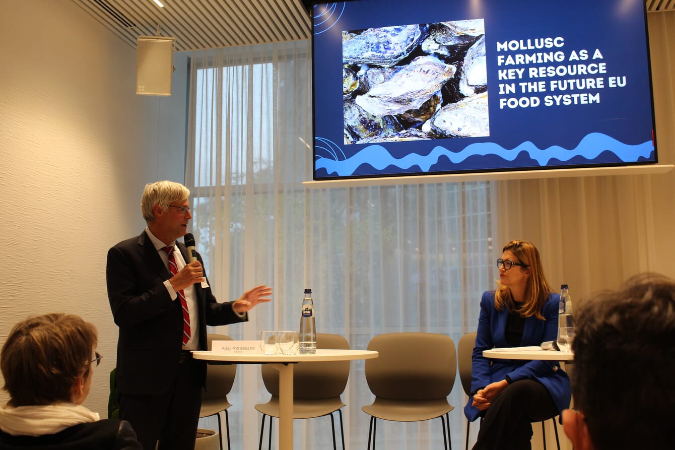 A man and woman giving a presentation about the importance of shellfish farming in Europe.