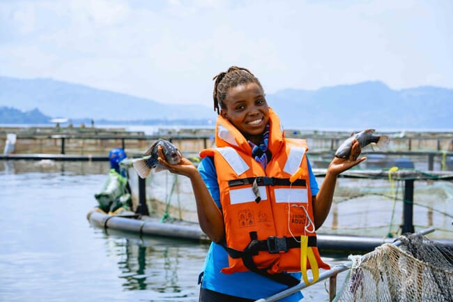 A woman holding tilapia.