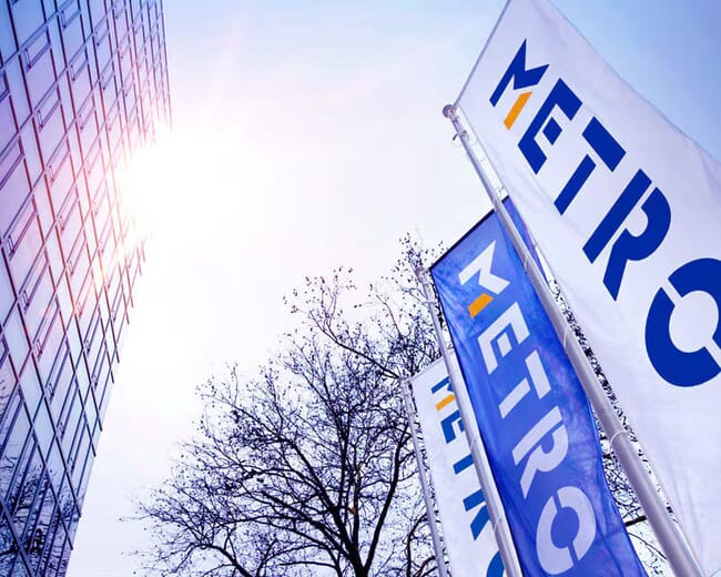 A photo of flags with Metro's logo in the sky.