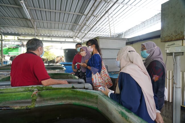 people standing by water tanks