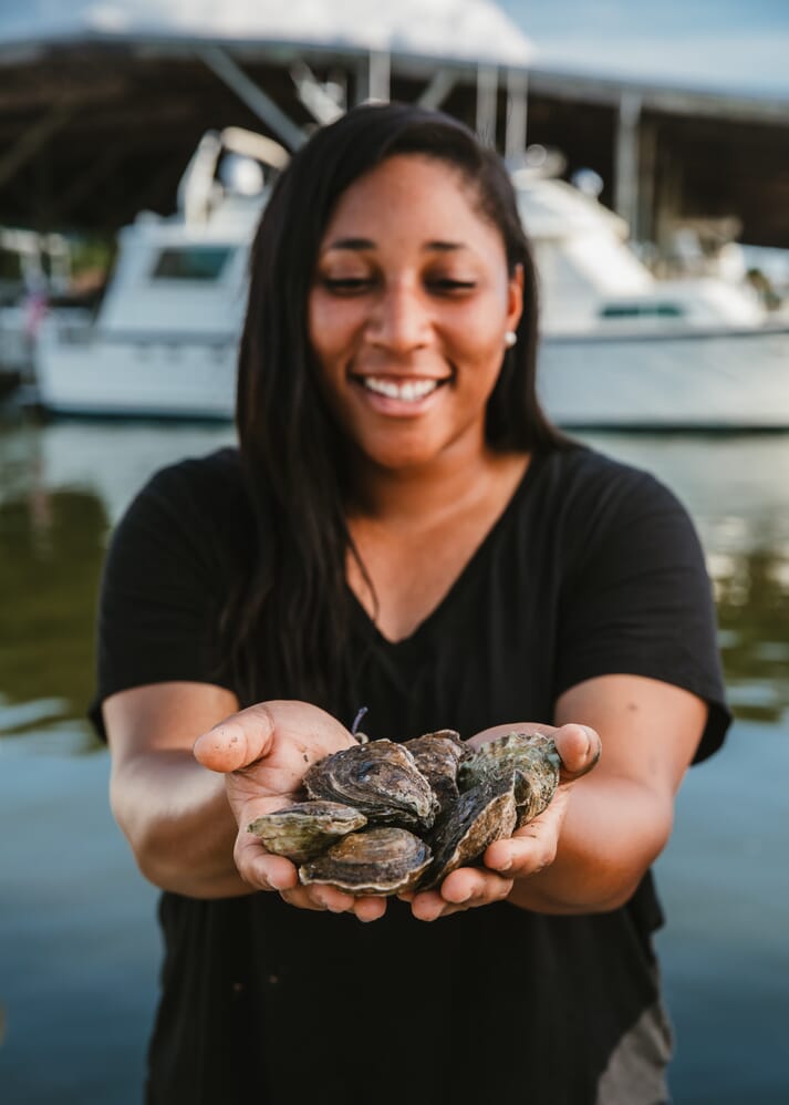 woman holding oysters