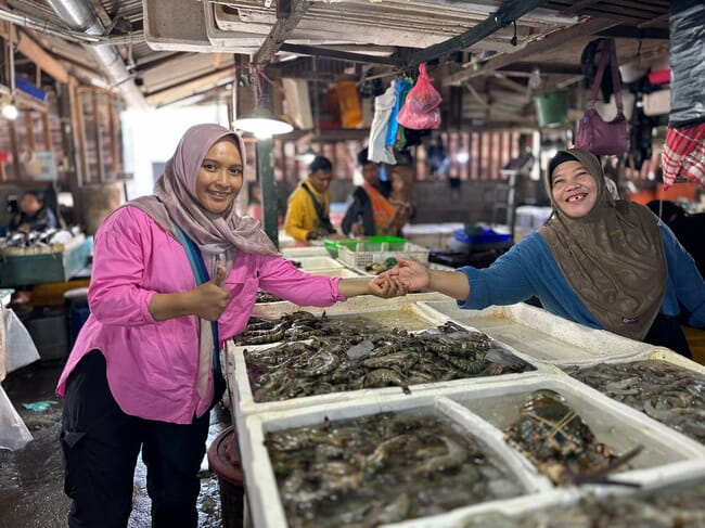 Ita Sualia at a shrimp market