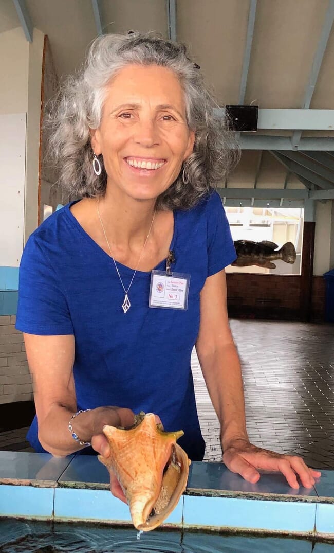 woman holds conch